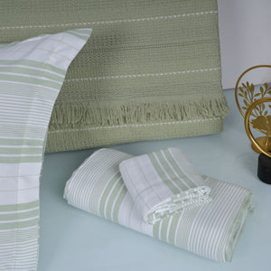 Green and white striped bedding set on a bed