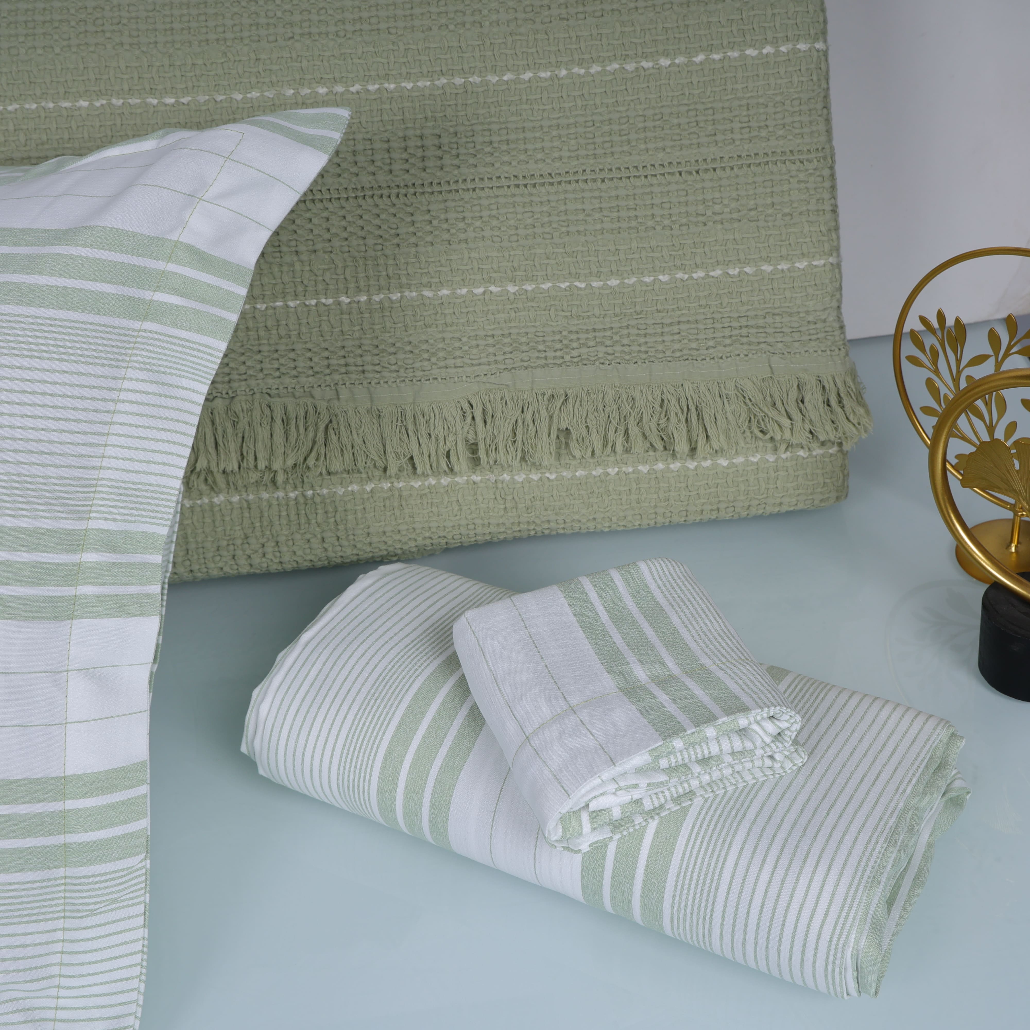 Green and white striped bedding set on a bed