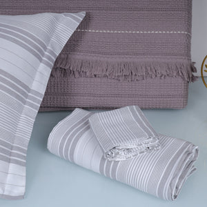 Folded striped blanket with a textured throw