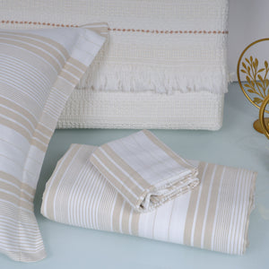 Folded and stacked bedding sets with striped patterns 