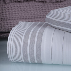 Folded gray and white striped fabric 