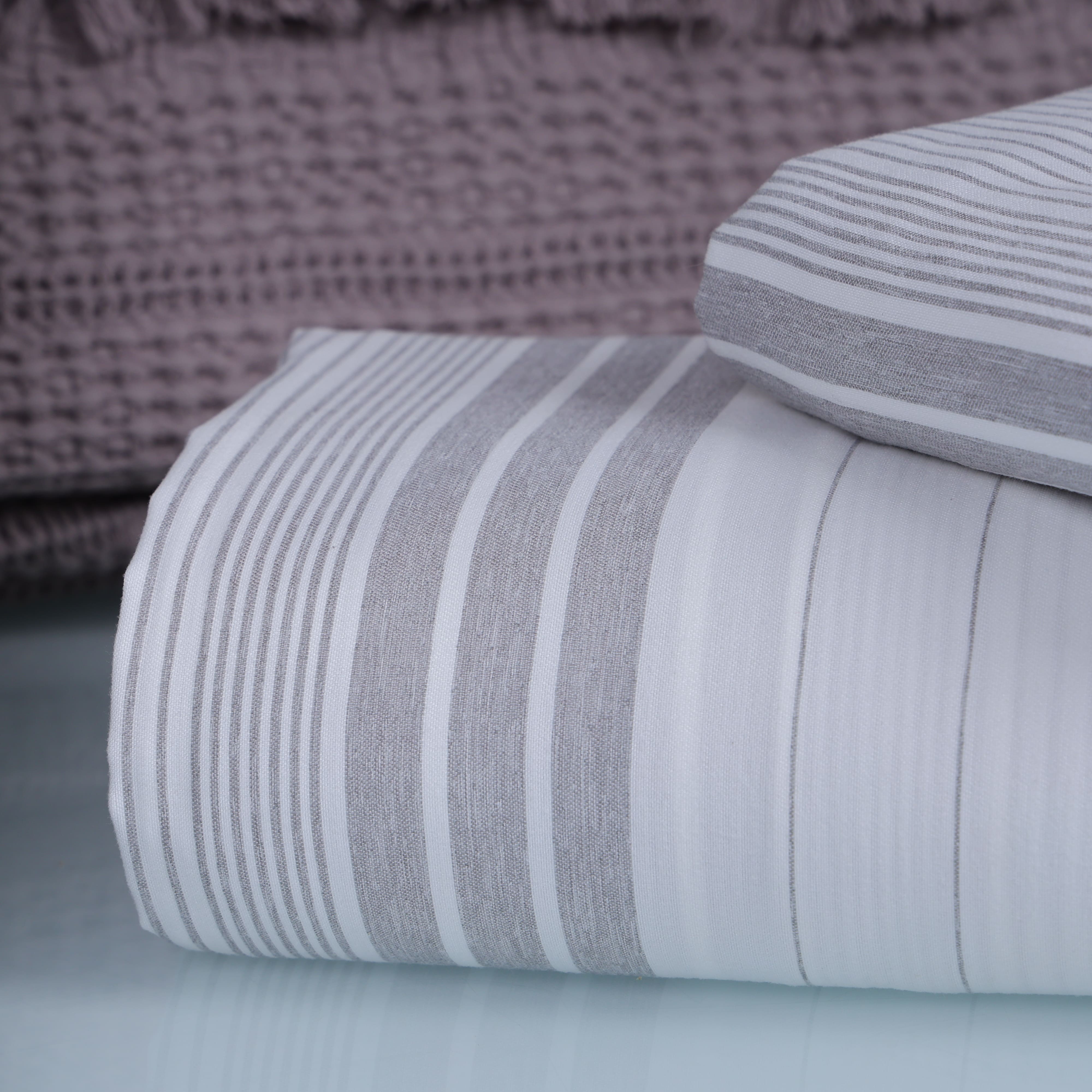 Folded gray and white striped fabric 